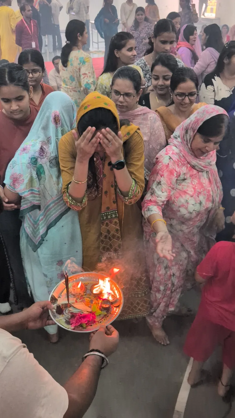 Students sharing aarti during a campus celebration